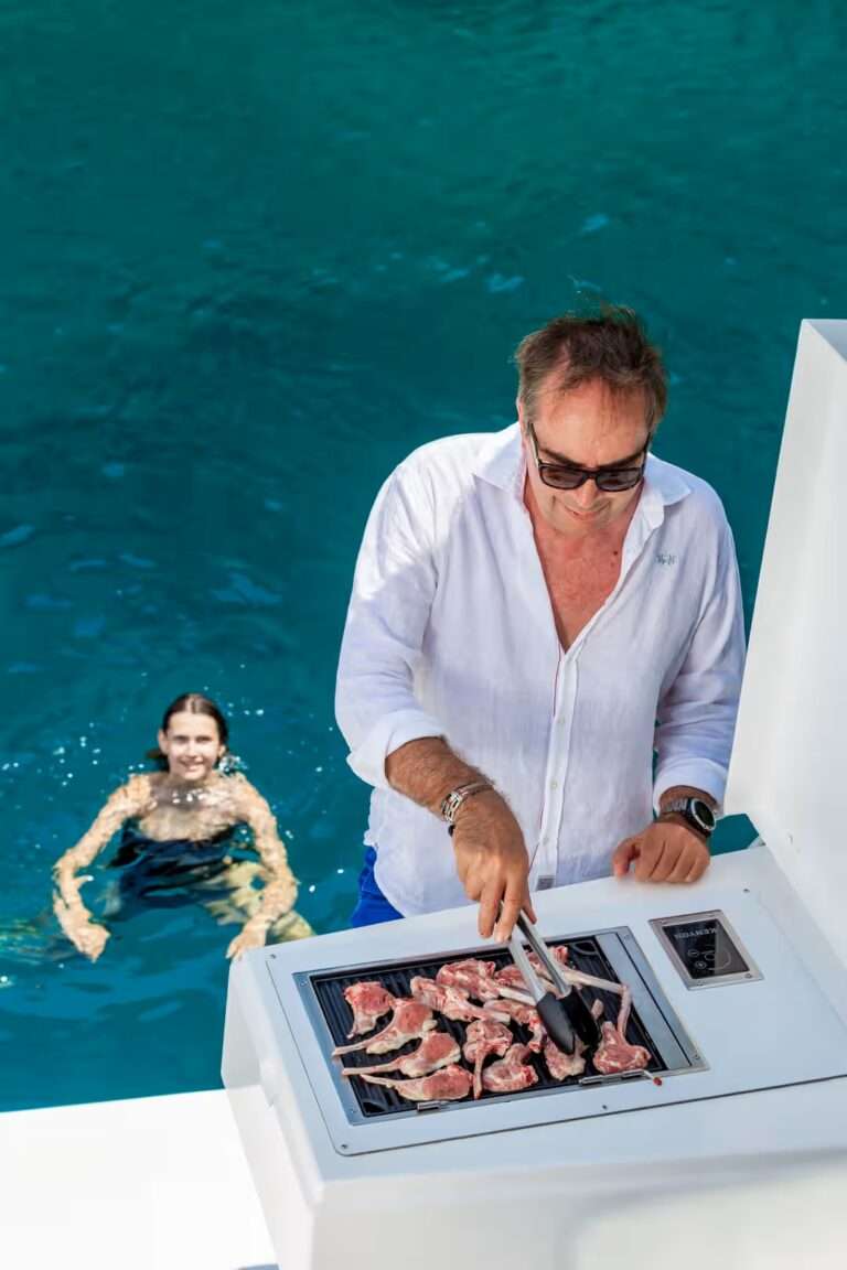Catamaran BALI Homme preparant des grillades a bord du Bali 5 4
